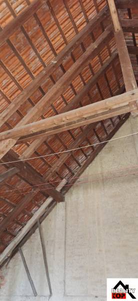 A view of the roof structure in a family house with a brick covering.