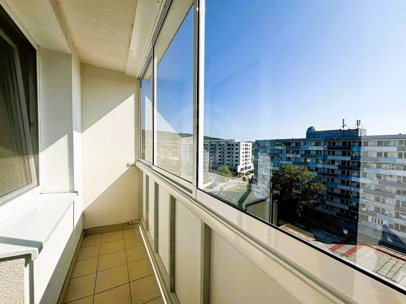 Enclosed balcony of a 2-room apartment in Bratislava - Vajnory with a view of the housing estate.