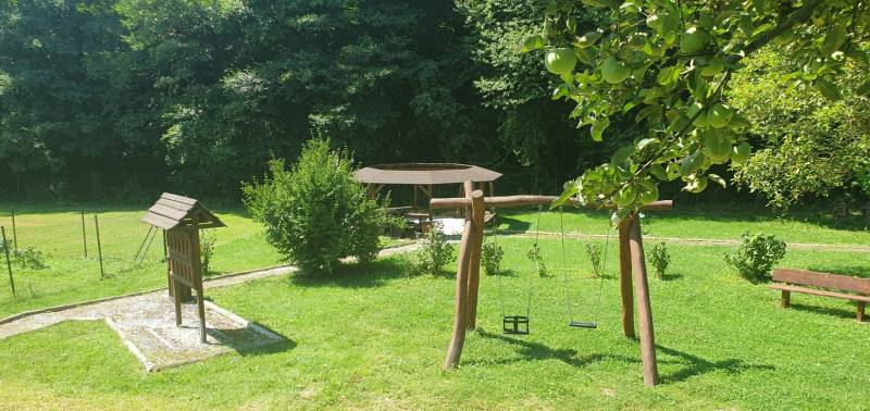 Garden with a swing and a shelter on Hviezdoslavova Street in Tisovec near the cottage.