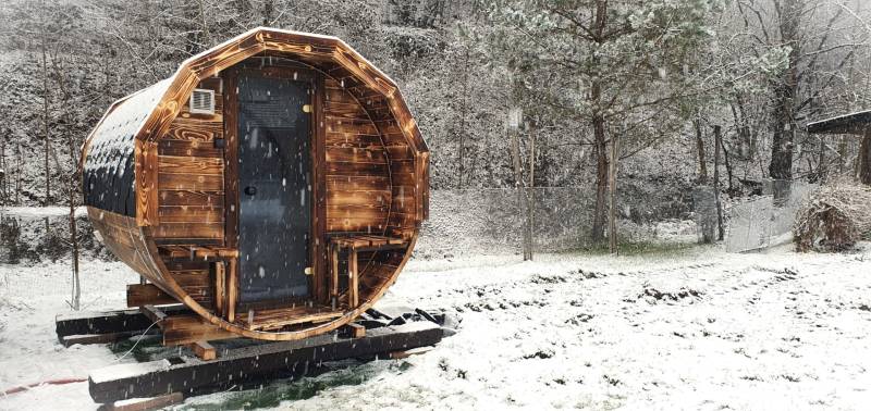 Snow-covered barrel-shaped cottage on Hviezdoslavova Street in Tisovec.