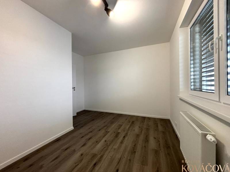 A bright room with a wooden decor floor in a 3-room apartment.