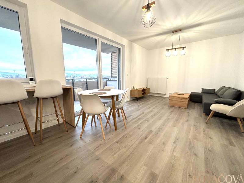 Living room in a 3-room apartment with a wooden decor floor and modern furniture.