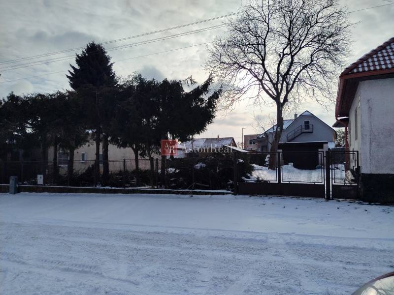 A family house on Hájska Street in Martin with a gate and a snowy yard.