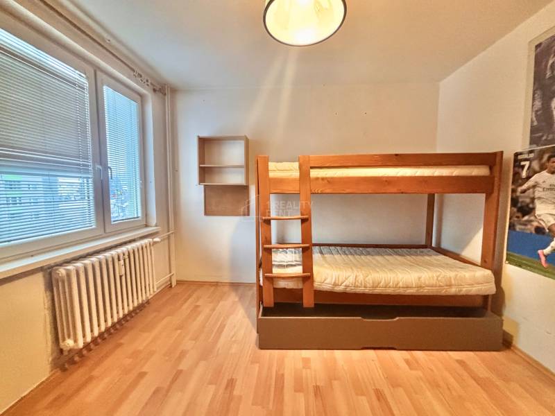 Children's room in a three-room apartment with a bunk bed and a floor with a wooden decor.