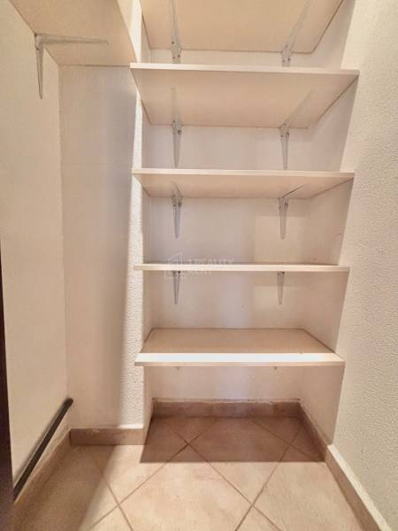 Storage space with shelves and tiles in a 3-room apartment.