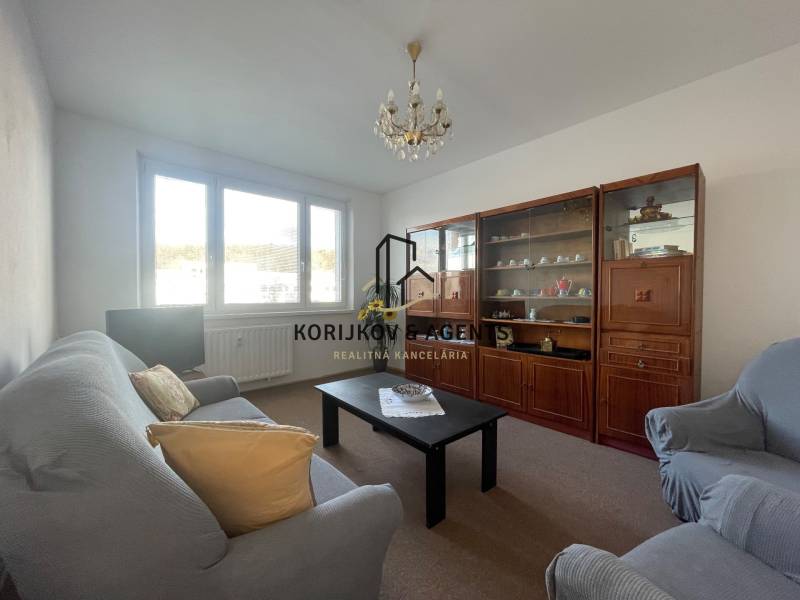 Living room in a 3-room apartment with a sofa, armchairs, and a wall unit.