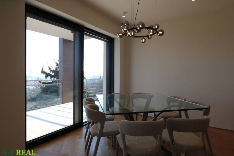 Dining table with a glass top, floor with wood decor, light fixture in a 4-room apartment.