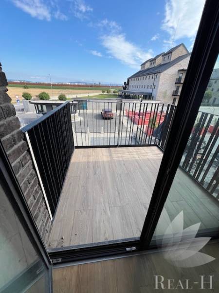 The balcony of a 2-room apartment at Námestie pri sýpke in Bratislava - Jarovce with a view of the surroundings.