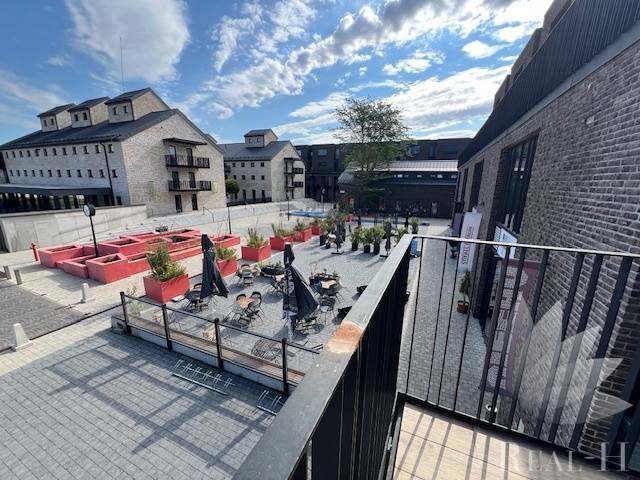 Square exterior at Sýpka in Bratislava - Jarovce with a terrace and brick buildings.