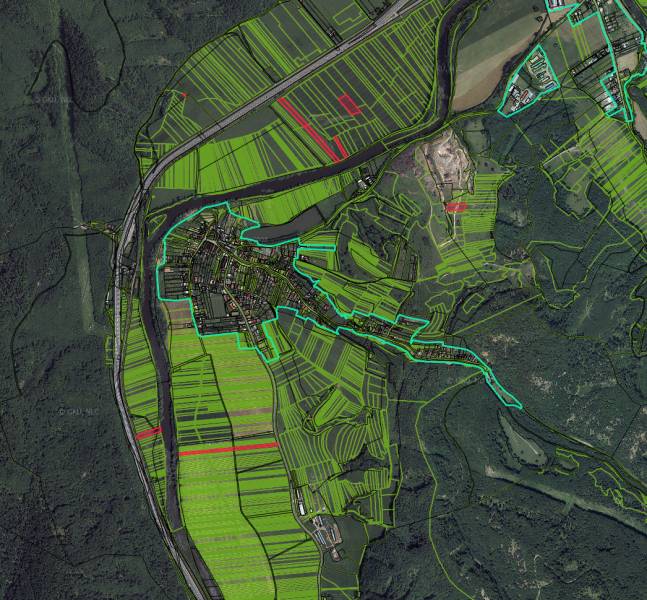 Aerial view of agricultural and forest lands in the Žarnovica area with prominent green areas.