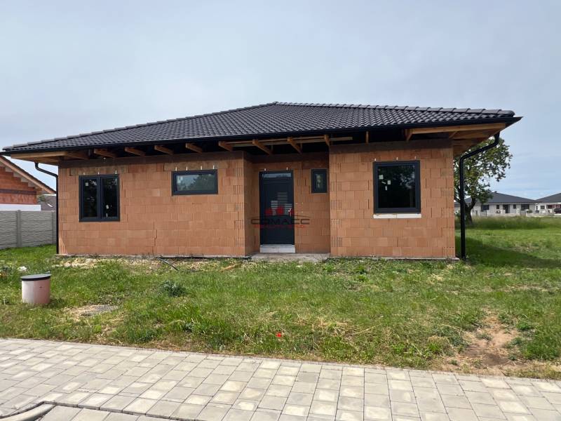 A family house on M.R. Štefánika in Madunice with basic brick walls and a dark roof.