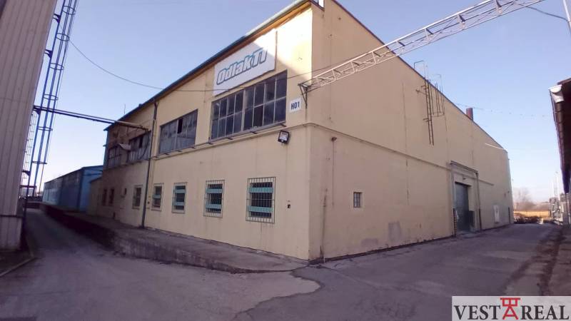 Building on Coburg Street in Trnava, warehouses and halls, yellow exterior, industrial architecture.
