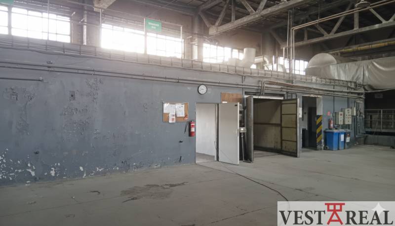 Industrial interior with gray walls, doors, and ventilation system in the warehouse and hall.