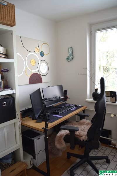 Office corner in a 3-room apartment with a computer and wall decorations.