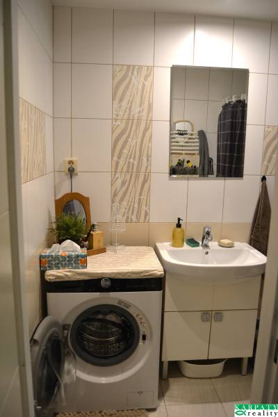 Bathroom in a 3-room apartment with a mirror, sink, and washing machine.