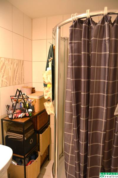 A bathroom with a partition and storage spaces in a 3-room apartment.