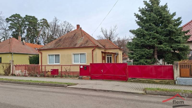 Family house in Nová Ves nad Žitavou on Nová Ves nad Žitavou street with a distinctive red fence.