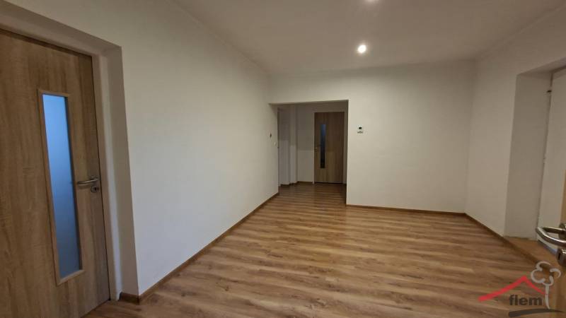 Interior of a family house with white walls and a wooden decor floor.