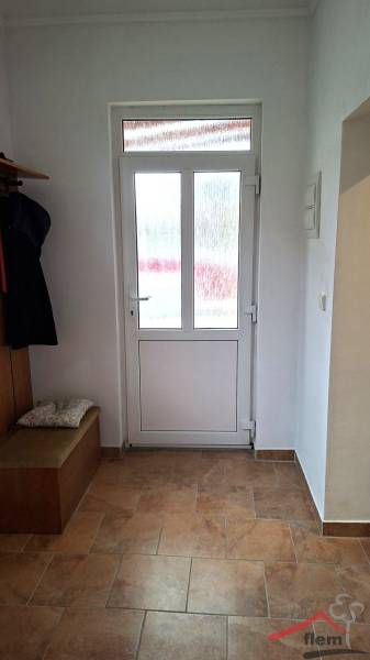 Interior of a family house with glass doors and a wooden decor floor.