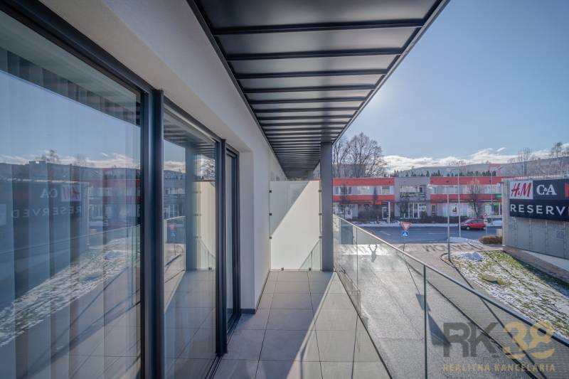 A balcony with a glass railing at a 2-room apartment on Francisciho Street in Poprad.