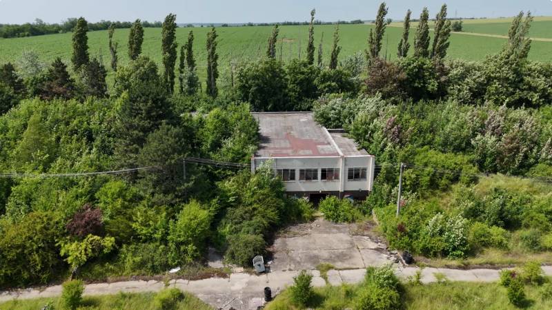 A building surrounded by vegetation, suitable for commercial land in Ivanka pri Nitre.