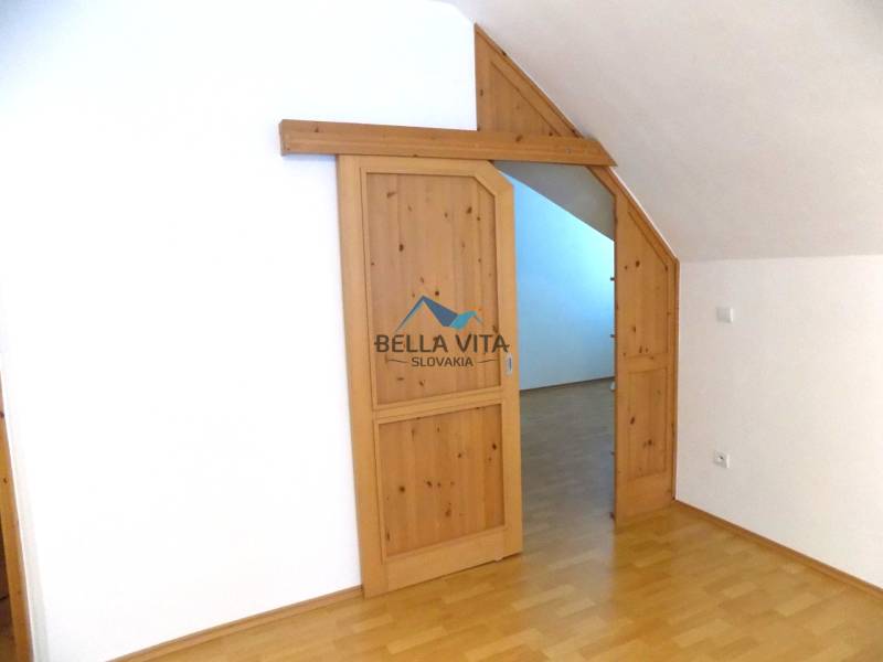 Interior with wood-patterned flooring and sliding doors in a building.