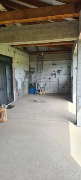 The interior of a family house with gaudy walls, a ladder, and construction materials.
