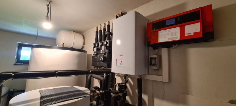 Technical equipment in a family house with a boiler and a water tank.
