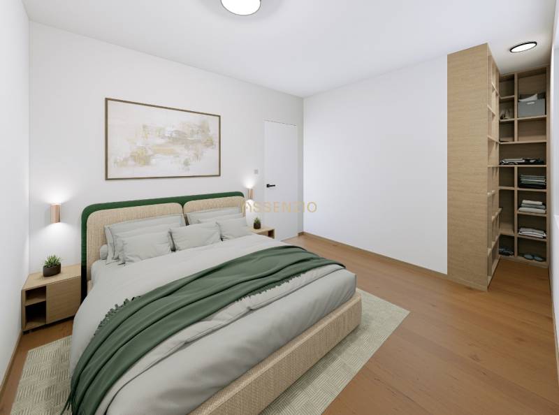 Bedroom in a 2-room apartment with a bed, a painting, and a floor with a wooden decor.