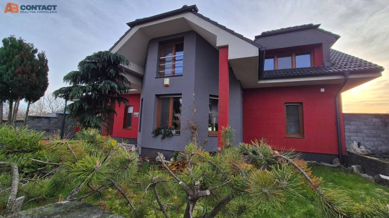 A family house on Veterná Street in Krakovany, surrounded by trees and a landscaped garden.