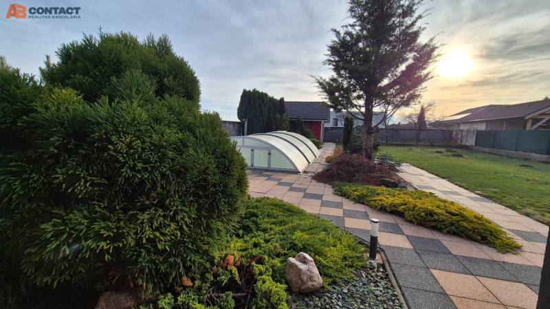 The garden at the family house on Veterná Street in Krakovany with a pool cover.