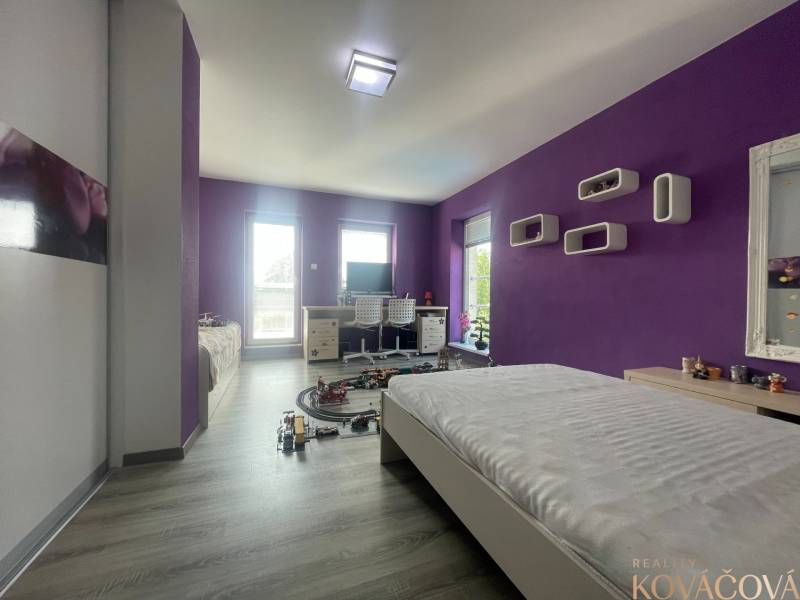 Purple and white children's room with wood-patterned flooring in a family house.