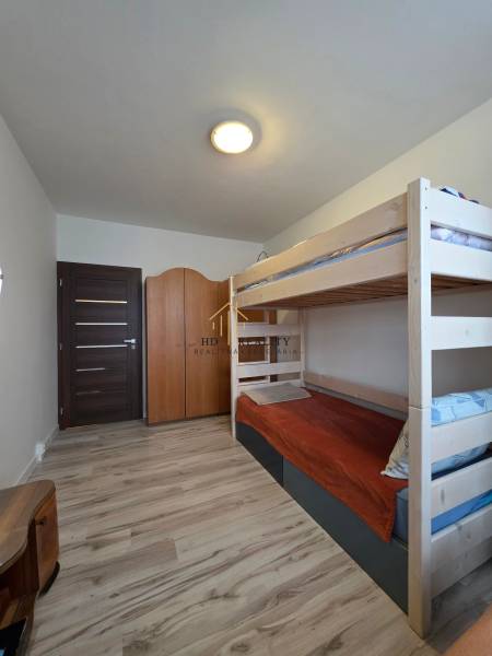 Children's room with a bunk bed and a wooden decor floor in a 3-room apartment.