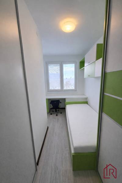 A cozy room with a bed, a desk, and storage space in a 3-room apartment.