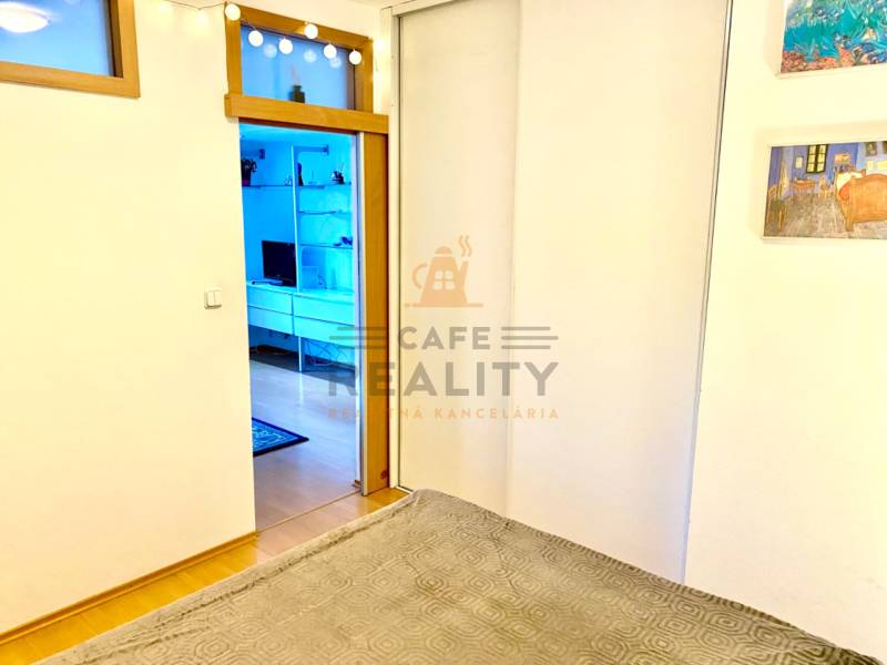 Interior of a 2-room apartment with sliding doors and a floor with a wood decor.