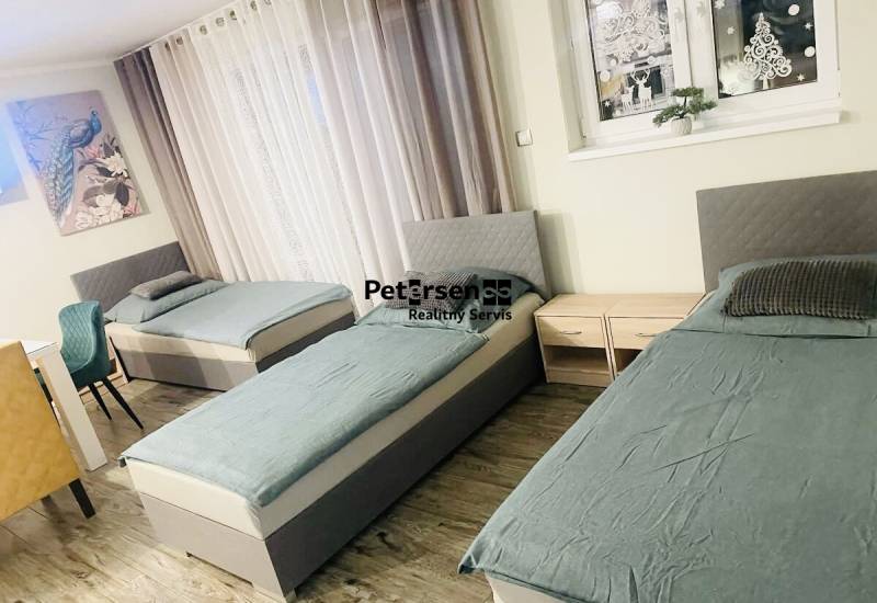 Three beds, two nightstands, and a wooden-decor floor in a family house.