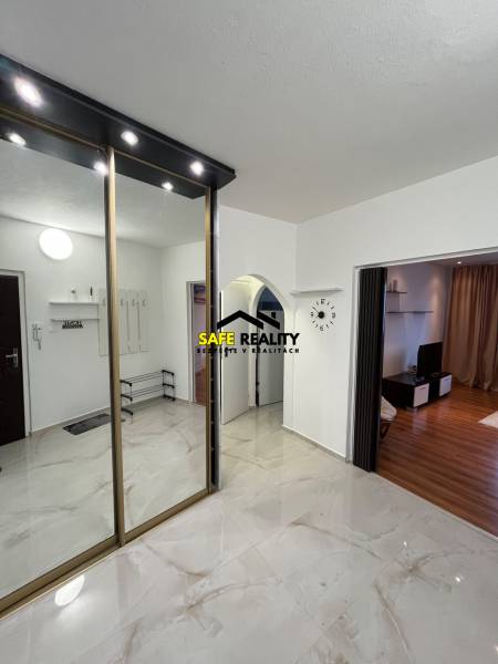 In the 3-room apartment, there is a mirrored wardrobe and a wooden decor floor in the living room.