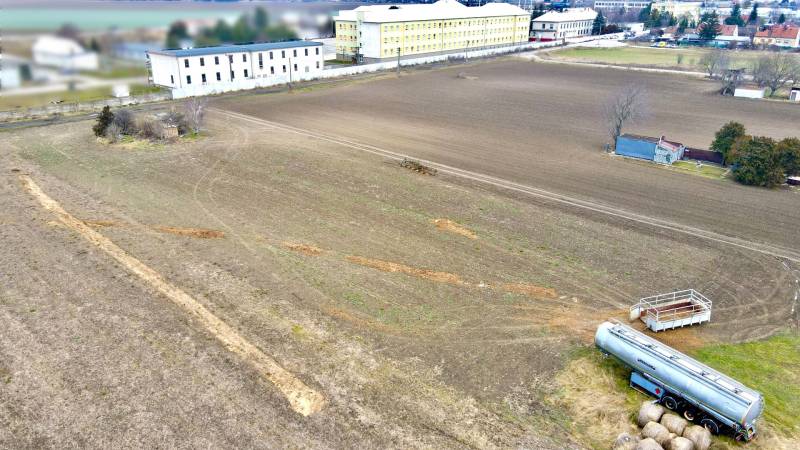 Lands - housing on Kasárenská Street in Sereď with extensive fields and warehouses.