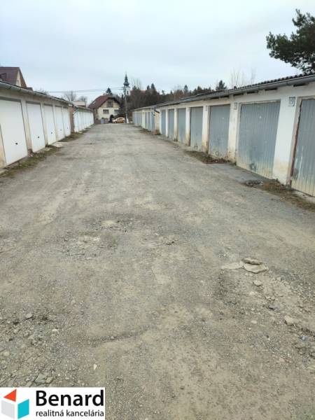 Garages on Urxova Street in Prešov, with a long stone path between them.