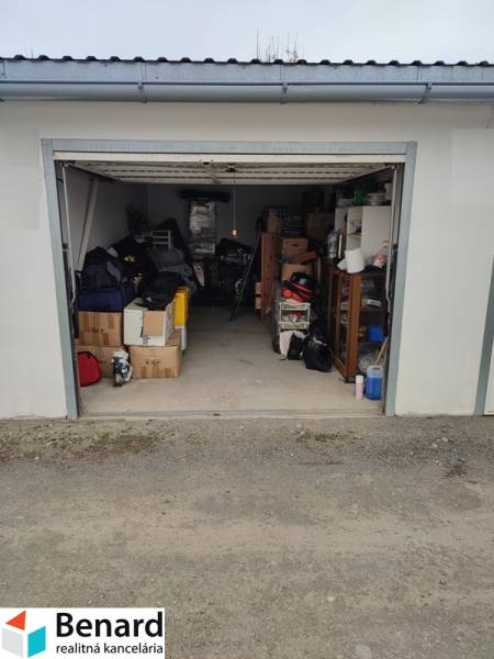 An open garage on Urxova Street in Prešov with various stored equipment and furniture.