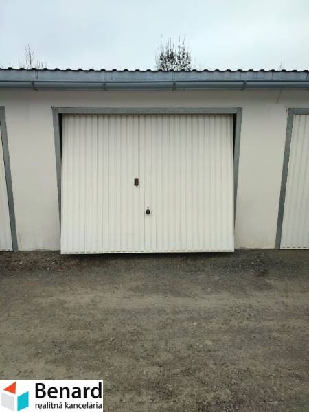 Garage on Urxova Street in Prešov with white doors on a gravel surface.