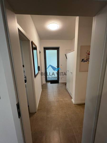 Hallway in a 2-room apartment with ceramic tiles on Brečtanová Street.