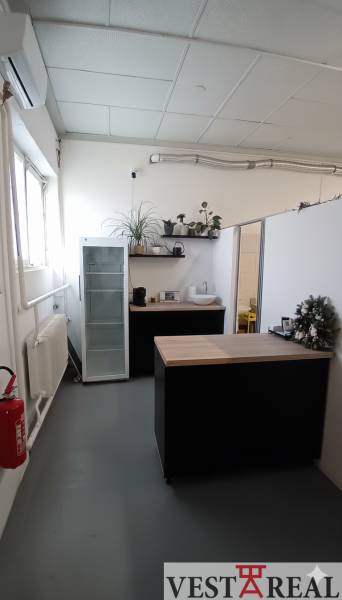 Interior with a table, sink, shelves, and a white cabinet in warehouses and halls.