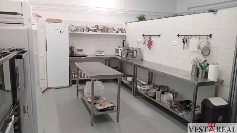 A professional kitchen from warehouses and halls, with stainless steel equipment and appliances.