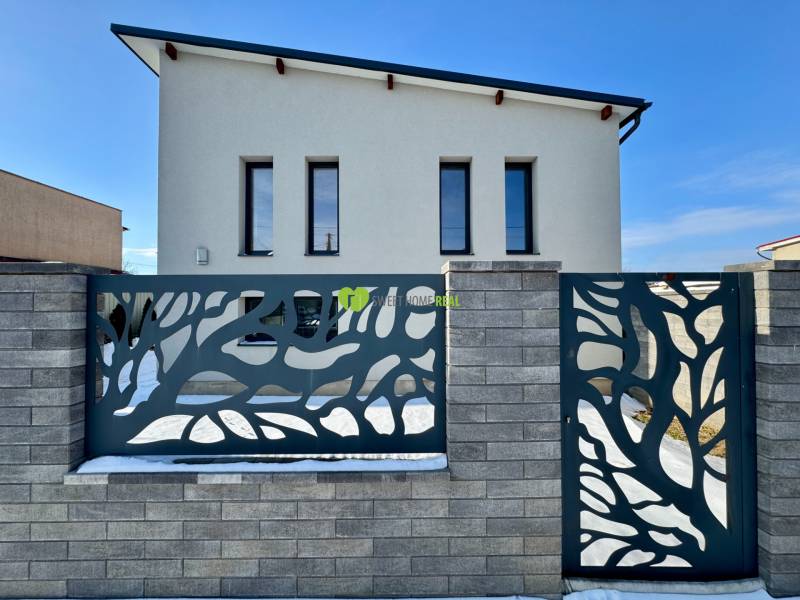 A family house on Gyňovská Street in Čaňa with a modern fence and a simple facade.