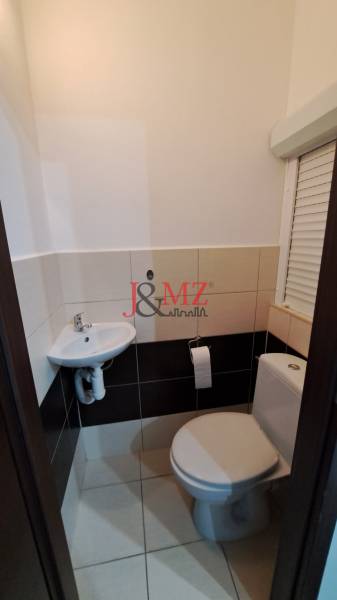 Bathroom in a 2-room apartment with a toilet and a sink.