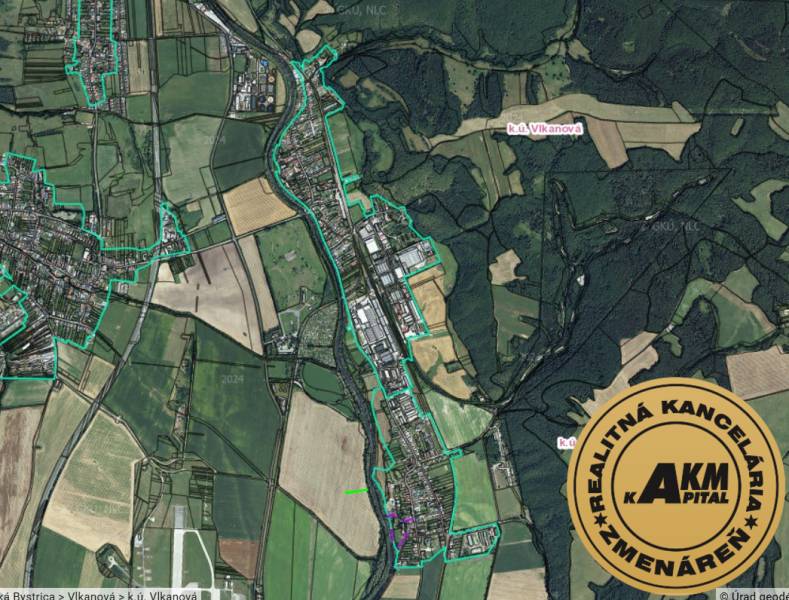 An aerial view of agricultural and forest lands around Badín.