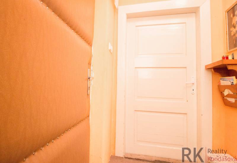 Doors with paneling, shelf, and orange wall in the interior of a family house.