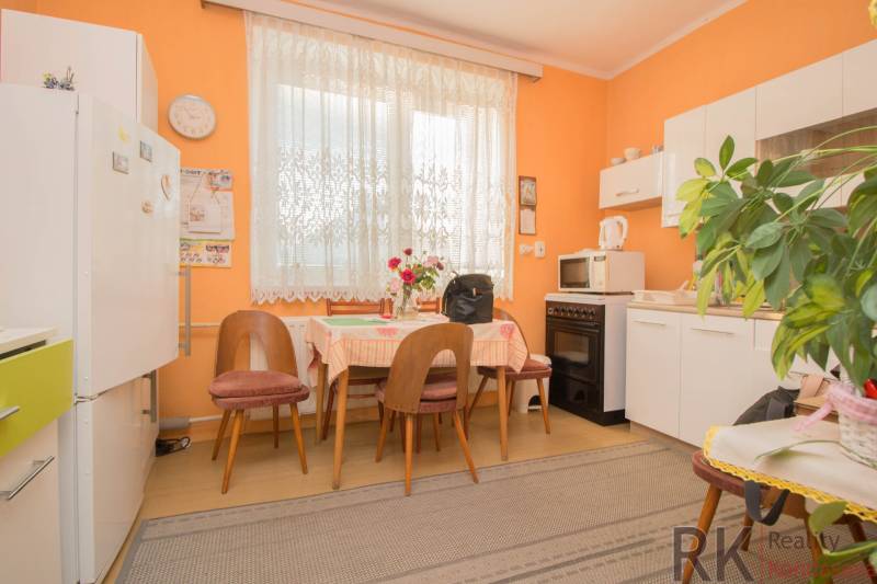 A kitchen with furniture and home accessories in a family house, floor with wooden decor.