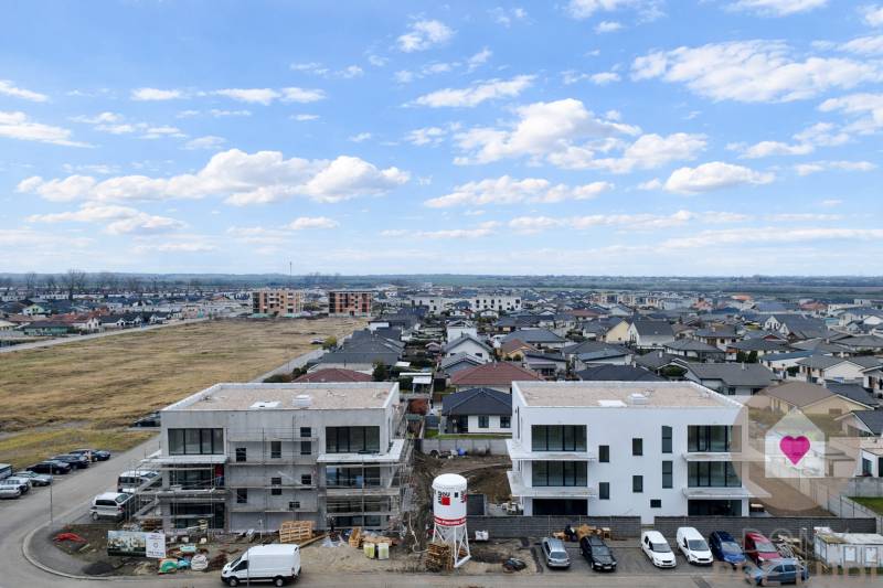 New buildings on Dúhová Street in Slovenský Grob with a view of the surrounding development.